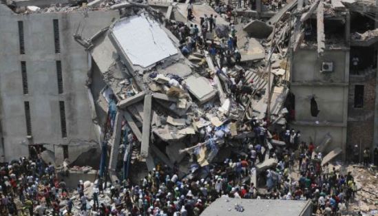 People rescue garment workers trapped under rubble at the Rana Plaza building after it collapsed, in Savar